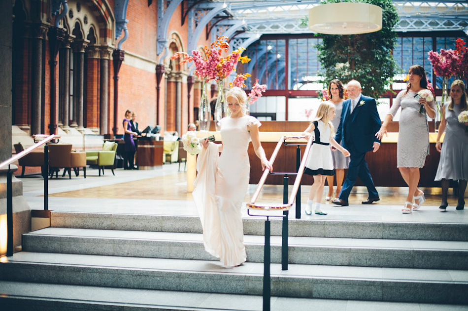 The bride wears a Belle & Bunty gown in blush for her child and family friendly wedding at Trinity Buoy Wharf in London. Photography by Kat Green.